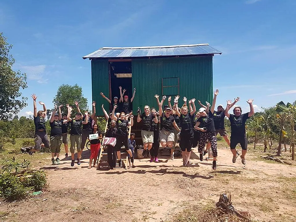 The Volunteerbuild team jump for joy as they hand over yet another quality build in Cambodia